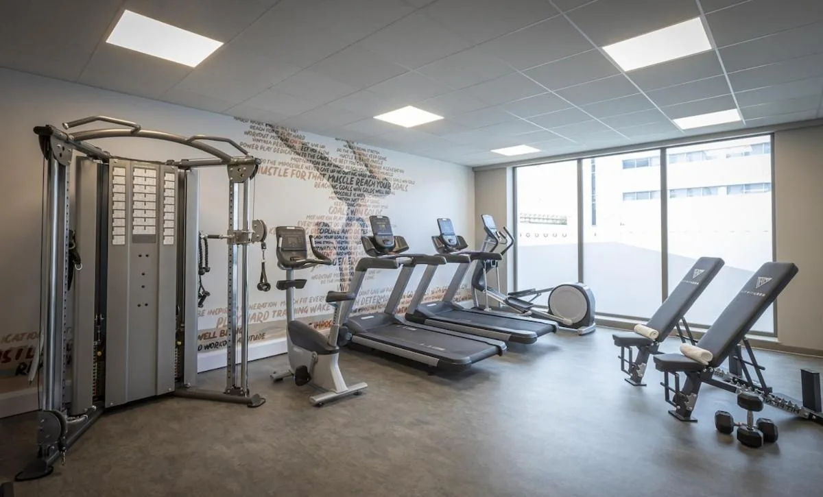 a gym with several treadmills and cardio machines at Maldron Hotel Glasgow City in Glasgow